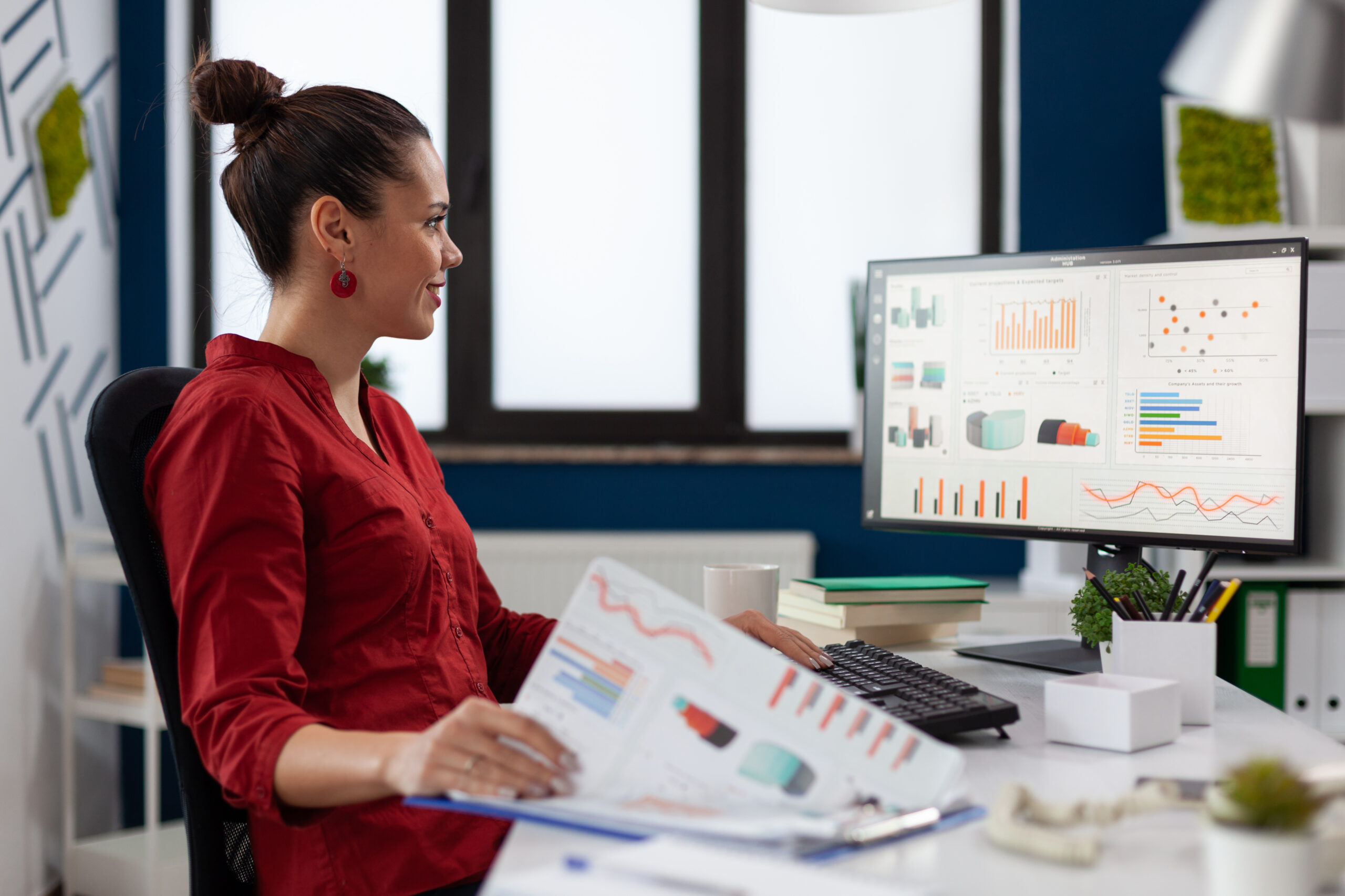 Businesswoman With Clipboard Sitting Desk Startup Business Office Smiling Employee Red Shirt Comparing Charts Successful Entrepreneur Looking Desktop Computer Analyze Business Data Scaled